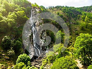 Majestic water cascade of Powerscourt Waterfall, the highest waterfall in Ireland.