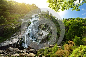 Majestic water cascade of Powerscourt Waterfall, the highest waterfall in Ireland.