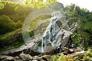 Majestic water cascade of Powerscourt Waterfall, the highest waterfall in Ireland. Tourist atractions in co. Wicklow, Ireland