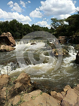 Majestic waterfall cascades down a rocky river in Sikwane, Botswana