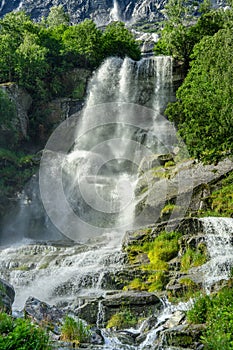 Majestic waterfall surrounded by lush green vegetation