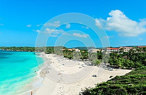 majestic wide open stunning inviting beach with people swimming, relaxing and enjoying their time on sunny beautiful day in turqu