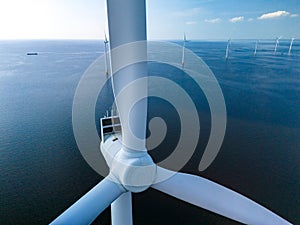 A majestic wind turbine stands tall in the middle of the ocean, harnessing the power of the wind to generate clean photo