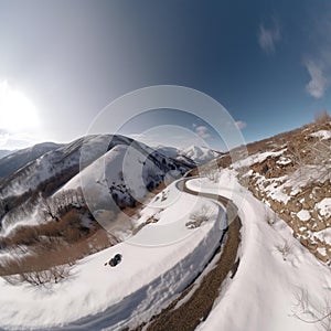 Majestic Winter Wonderland - A serene snowy mountain landscape with a winding road leading into the distance.