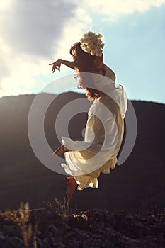 Majestic woman flying in sunset light