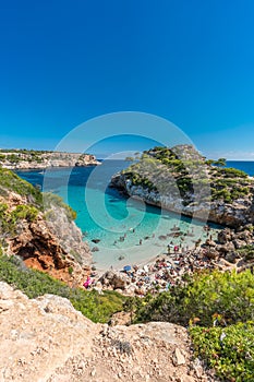People enjoying sun at Es calo des Moro beach Clasified as one of the best beaches in the world.