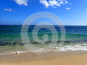 Makalei Beach with waves lapping on a wonderful day