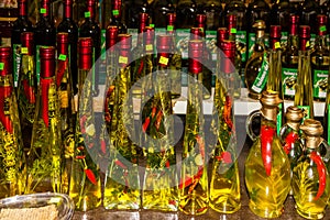 Croatia: Olive oil bottles with pepper on the Makarska market - traditional Croatian souvenirs