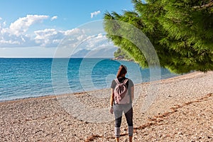 Makarska - Hiker woman on idyllic stone beach in coastal town Makarska, Dalmatia, South Croatia, Europe