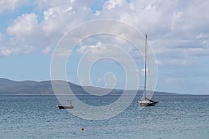 Makarska - Scenic view of sailing boat in turquoise lagoon seen from idyllic beach in coastal town Makarska, Split-Dalmatia