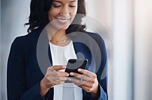 Make those connections that will help your business grow. a young businesswoman using a cellphone in an office.