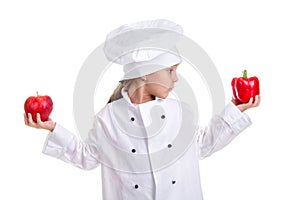 Make a decision. Chef girl in a cap cook uniform with both arms up, holding red bell pepper in one hand and the red