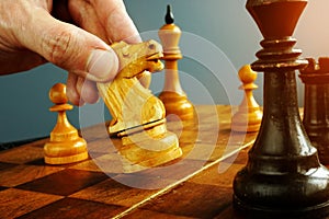 Make decisions and challenge. Chess player makes a move photo