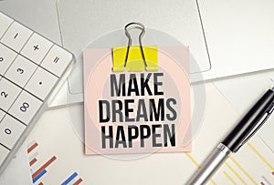 make dreams happen symbol. pink paper sheet and pen, calculator and charts