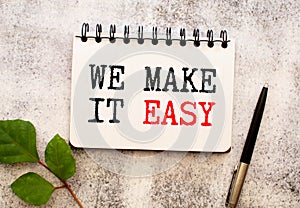 We make it easy text on white notepad paper on white background NEXT TO THE CALCULATOR