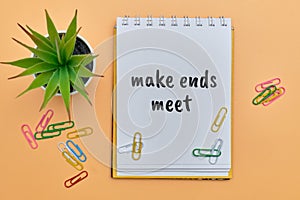 Make ends meet - english money idiom hand lettering on wooden blocks