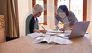 They make a great team. A cropped shot of two focused women working together in a home office.