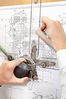 Make hands making a project on blueprint