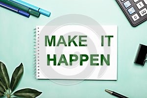 MAKE IT HAPPEN is written on a white sheet on a blue background near the stationery and the sheffler sheet. Call to action.