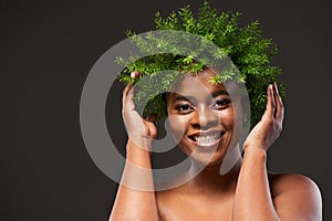 Make happiness as routine as your beauty regime. Studio shot of a beautiful young woman wearing a leaf wreath on her