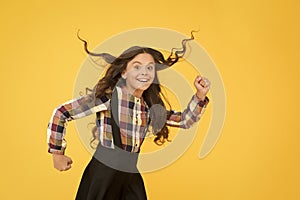 Make haste slowly. Energetic girl hurry to school. Small child wear long hairstyle yellow background. Back to school