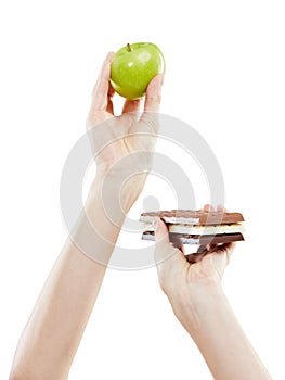 Make healthy choices every day. Studio shot of a woman deciding between healthy and unhealthy foods.