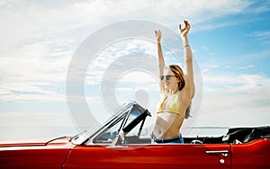 Make life a permanent vacation. a happy young woman enjoying a summers road trip.