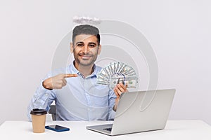 Make money online! Angelic rich businessman with nimbus on head pointing dollar banknotes, encouraging to earn