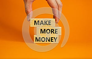 Make more money symbol. Concept words Make more money on blocks on beautiful orange table orange background. Business, make more