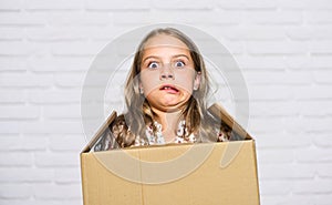 Make moving easier. Girl small child carry cardboard box. Move out concept. Prepare for moving. Rent house. Real estate photo
