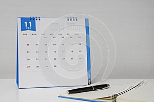 Make note on notebook with November calendar