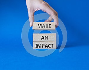 Make a plan symbol. Concept word Make a plan on wooden blocks. Businessman hand. Beautiful blue background. Business and Make a