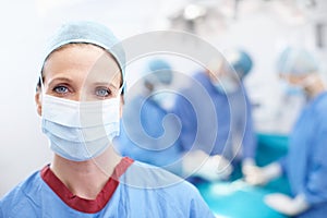 Make the right choices for your health. Closeup portrait of confident female surgeon in an operating theatre wearing a