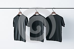 Make a sign concept with three blank black t-shirts