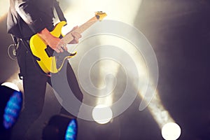 Make those string sing. a musician performing a guitar solo on the stage.