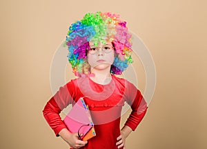 Make studying fun. Truly happy childhood. Girl cute playful child wear curly rainbow wig. Life is fun. Happy little