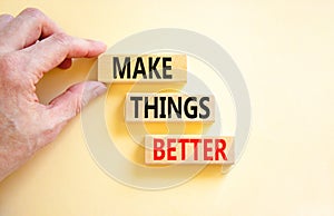 Make things better symbol. Concept words Make things better on wooden block on a beautiful white table white background.