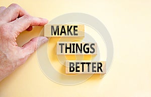 Make things better symbol. Concept words Make things better on wooden block on a beautiful white table white background.