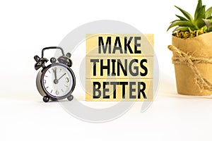 Make things better symbol. Concept words Make things better on wooden block on a beautiful white table white background. Black