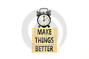 Make things better symbol. Concept words Make things better on wooden block on a beautiful white table white background. Black