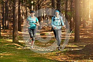 We make time for friendship and exercise. two sporty young women out exercising in nature.