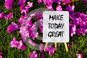 Make today great On background of pink flowers and green grass.