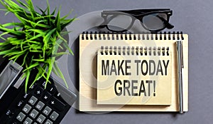 MAKE TODAY GREAT on the notepad with office tools, pen