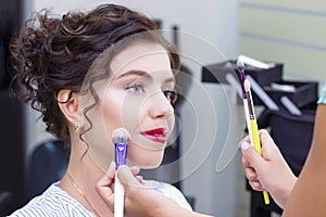 Make up artist applies a light layer of matte powder