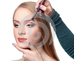 Make-up artist apply eyebrow shadow with brush, beauty photo