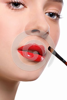 Make-up artist apply lipstick with brush, beauty photo