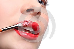 Make-up artist apply lipstick with brush, beauty photo