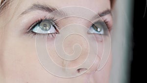 Make-up artist applying eyelash makeup to model`s eye. Close up view.