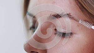 Make-up artist applying eyelash makeup to model`s eye. Close up view.