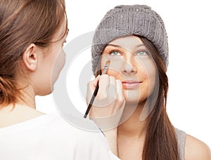 Make-up artist applying makeup onto performer's face